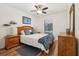 This bedroom features a ceiling fan, window, dresser, and a bed with blue decor at 1120 Parker Canal Ct, Oviedo, FL 32765