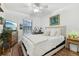 This bedroom features a ceiling fan, window, comfy bed, and warm color scheme at 1120 Parker Canal Ct, Oviedo, FL 32765