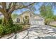 Charming home featuring a manicured lawn, mature trees, and a two-car garage at 1120 Parker Canal Ct, Oviedo, FL 32765