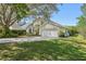 Well-maintained home with lush landscaping, large trees, and a two-car garage at 1120 Parker Canal Ct, Oviedo, FL 32765