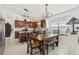 Eat-in kitchen featuring wood cabinets, tile backsplash, and a dining area at 1120 Parker Canal Ct, Oviedo, FL 32765