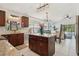 Spacious kitchen featuring dark wood cabinets, granite counters, and tile floors at 1120 Parker Canal Ct, Oviedo, FL 32765
