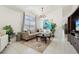 Bright living room featuring a chandelier, window and beige colored sectional sofa at 1120 Parker Canal Ct, Oviedo, FL 32765