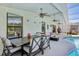 Covered patio with outdoor dining area, seating, and view of the pool at 1120 Parker Canal Ct, Oviedo, FL 32765