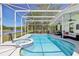 Screened-in pool and spa area with a view of the lake behind the property at 1120 Parker Canal Ct, Oviedo, FL 32765