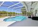 Screened in pool with a hot tub overlooking a serene lake at 1120 Parker Canal Ct, Oviedo, FL 32765