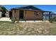 Rear view of a house with a covered porch and minimal landscaping at 124 Harrison Rd, Daytona Beach, FL 32118