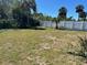 Spacious backyard featuring a white fence and sparse, natural vegetation at 124 Harrison Rd, Daytona Beach, FL 32118