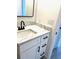 Modern bathroom vanity with a black faucet, marble countertop, and clean white cabinetry at 124 Harrison Rd, Daytona Beach, FL 32118