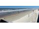 Picturesque sandy beach scene with calm waves and people enjoying a leisurely stroll at 124 Harrison Rd, Daytona Beach, FL 32118