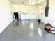 Spacious garage with epoxy flooring, laundry area, and natural light from a window at 124 Harrison Rd, Daytona Beach, FL 32118