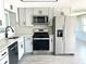 Modern kitchen featuring stainless steel appliances and gray cabinets at 124 Harrison Rd, Daytona Beach, FL 32118