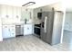 Stylish kitchen with stainless steel appliances, modern grey cabinets, and tile flooring at 124 Harrison Rd, Daytona Beach, FL 32118