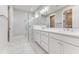 Contemporary bathroom featuring marble floors, a glass shower, and dual sinks at 1276 Jackson Hole Ct, Deland, FL 32724