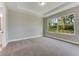 Spacious bedroom featuring neutral walls, carpeted floor, and large window with natural views at 1276 Jackson Hole Ct, Deland, FL 32724