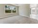Serene bedroom with neutral walls and a large window with a scenic view at 1276 Jackson Hole Ct, Deland, FL 32724