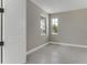 Neutral bedroom features grey walls, two windows with views, and white trim at 1276 Jackson Hole Ct, Deland, FL 32724