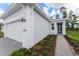 Exterior view showcasing the light stucco facade and a brick walkway to front door at 1276 Jackson Hole Ct, Deland, FL 32724