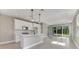 Open-concept kitchen featuring an island sink, stainless steel appliances, and light-filled living space at 1276 Jackson Hole Ct, Deland, FL 32724