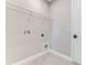 Practical laundry room showing wire shelving and utility connections at 1276 Jackson Hole Ct, Deland, FL 32724