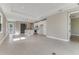 Bright, open-concept living space with modern kitchen featuring white cabinets and light-filled entryway at 1276 Jackson Hole Ct, Deland, FL 32724