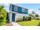 This two-story home features a blue exterior with a matching blue front door and manicured lawn at 13087 Salk Way, Orlando, FL 32827