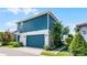This two-story home features a blue exterior with a matching blue garage door and front door at 13087 Salk Way, Orlando, FL 32827