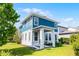 This two-story home features a blue exterior with a covered front porch and well-manicured lawn at 13087 Salk Way, Orlando, FL 32827