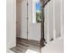 A view of the staircase in the house with white railings, and a hardwood floor at 13087 Salk Way, Orlando, FL 32827