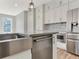 A kitchen featuring white cabinets, stainless steel appliances, and a kitchen island at 13087 Salk Way, Orlando, FL 32827