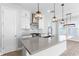 Beautiful kitchen with white cabinetry, stainless steel appliances, gray countertops, and a kitchen island at 13087 Salk Way, Orlando, FL 32827