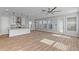 Spacious and bright living room with open floor plan, abundant natural light, and wood-look flooring at 13087 Salk Way, Orlando, FL 32827