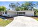 Charming single-story home with a large driveway and well-maintained landscaping in a lush, green setting at 1338 Franklin St, Altamonte Springs, FL 32701