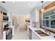 Bright kitchen features white cabinets, quartz countertops, and stainless steel appliances at 1338 Franklin St, Altamonte Springs, FL 32701