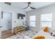 Bright bedroom featuring ceiling fan, work space, and white and gray rug at 135 W Grant St, Orlando, FL 32806