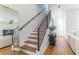 Modern staircase with wood steps, black railings, and open access to living room at 135 W Grant St, Orlando, FL 32806