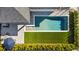 Aerial view of a pool and yard featuring a well-maintained hedge and outdoor furniture at 14004 Gullstrand Ave, Orlando, FL 32827