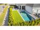 Aerial view of a pool and yard featuring a well-maintained hedge at 14004 Gullstrand Ave, Orlando, FL 32827