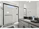 Bathroom features a glass-enclosed shower, sleek fixtures, and a gray vanity at 14004 Gullstrand Ave, Orlando, FL 32827