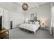 Bedroom with carpeted floors, a queen bed, neutral tones, side tables, and natural light from the window at 14004 Gullstrand Ave, Orlando, FL 32827