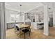 Open-concept dining area with modern lighting, stylish furniture, and kitchen views at 14004 Gullstrand Ave, Orlando, FL 32827