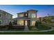 An exterior view of a two-story home with a modern design, set in a residential neighborhood at 14004 Gullstrand Ave, Orlando, FL 32827