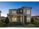 Exterior showcasing the home's architectural design, including a covered porch and mixed-material facade at 14004 Gullstrand Ave, Orlando, FL 32827