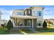Exterior shot of a modern home with stone accents and a welcoming covered front porch at 14004 Gullstrand Ave, Orlando, FL 32827