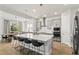 Sleek kitchen featuring a large island, modern appliances, and open dining area at 14004 Gullstrand Ave, Orlando, FL 32827
