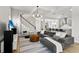 Open living area with a gray sofa, stylish rug, and access to the dining and kitchen areas at 14004 Gullstrand Ave, Orlando, FL 32827