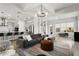 Spacious living room connected to the kitchen, featuring a comfortable gray sofa, and modern lighting at 14004 Gullstrand Ave, Orlando, FL 32827
