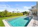 Inviting pool featuring a well-maintained yard and hedge at 14004 Gullstrand Ave, Orlando, FL 32827