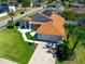 Aerial view of the home featuring lush landscaping, a manicured lawn, and a two-car garage at 14901 Wild Wood Lily Ct, Orlando, FL 32824