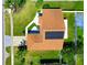 Aerial view of the home showcasing its roof, solar panels, and landscaped surroundings at 14901 Wild Wood Lily Ct, Orlando, FL 32824